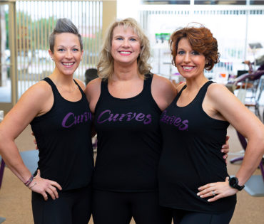 Three Women Wearing Curves Singlets