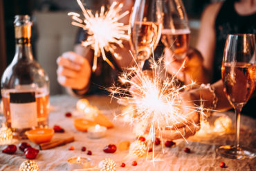 Dinner party with people holding sparklers