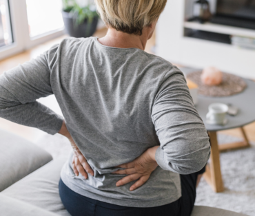 Woman holding her lower back